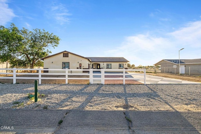 40719 E 171st St E, Lake Los Angeles, CA 93535 - view of front of property with a fenced front yard, stucco siding, and driveway
