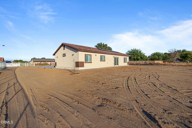 40719 E 171st St E, Lake Los Angeles, CA 93535 - rear view of property featuring roof mounted solar panels and fence
