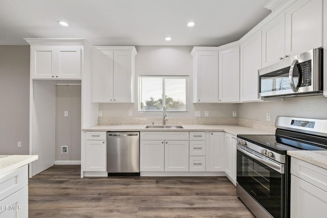 40719 E 171st St E, Lake Los Angeles, CA 93535 - kitchen featuring appliances with stainless steel finishes, a sink, white cabinets, recessed lighting, and dark wood finished floors