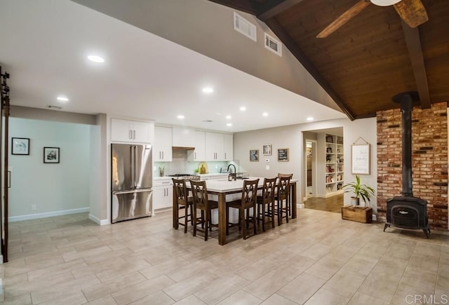 2444 Via Dieguenos, Alpine, CA 91901 - dining area with a wood stove, ceiling fan, baseboards, and recessed lighting