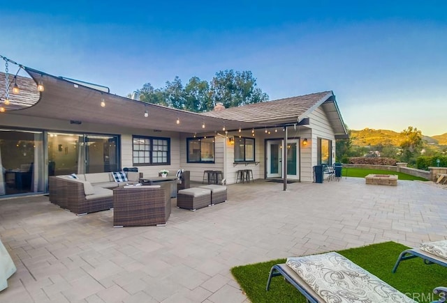2444 Via Dieguenos, Alpine, CA 91901 - patio terrace at dusk with an outdoor living space with a fire pit