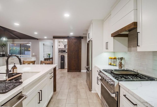 2444 Via Dieguenos, Alpine, CA 91901 - kitchen featuring high quality appliances, a sink, a barn door, decorative backsplash, and recessed lighting