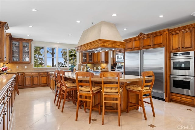 1502 Paseo La Cresta, Palos Verdes Estates, CA 90274 - kitchen with built in appliances, custom range hood, backsplash, a kitchen breakfast bar, and recessed lighting