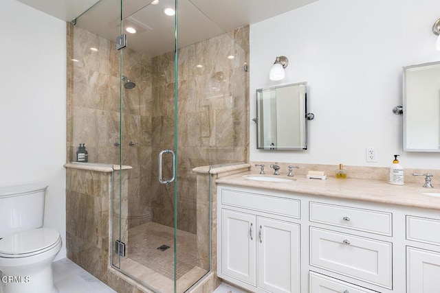 bathroom featuring a shower stall, toilet, double vanity, and recessed lighting