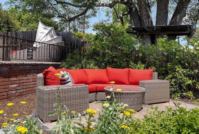 view of patio / terrace featuring an outdoor hangout area and a fenced backyard