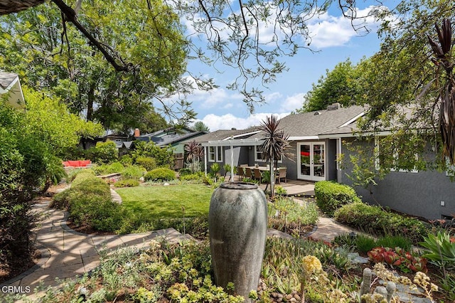 back of property featuring french doors, a patio, and a lawn
