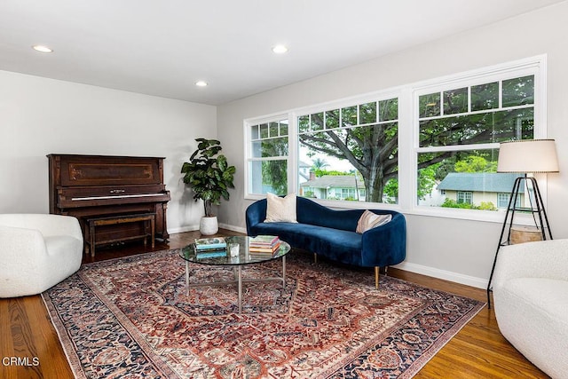 living area with wood finished floors, baseboards, and recessed lighting