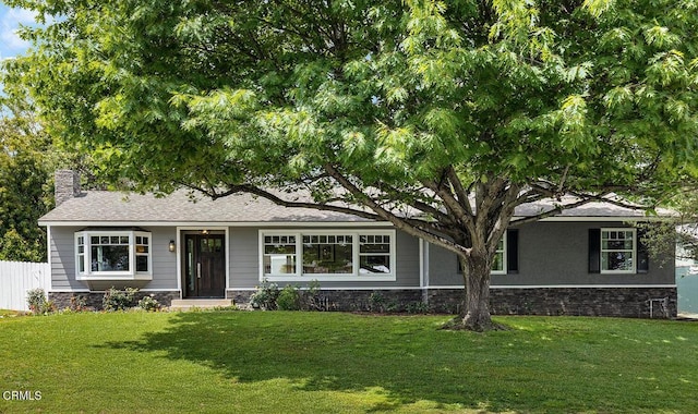 ranch-style home with stone siding and a chimney