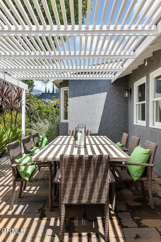 view of patio featuring outdoor dining space and a pergola