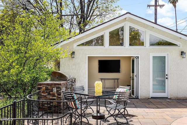 view of patio / terrace with exterior kitchen and outdoor dining space