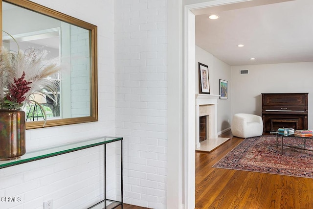 hall with wood finished floors and recessed lighting
