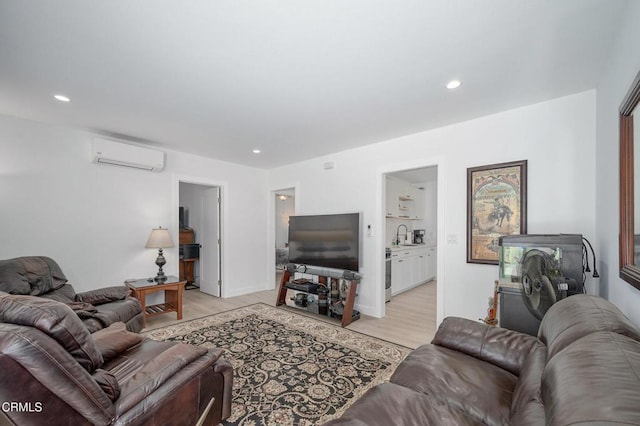 living room featuring a wall mounted air conditioner, light wood-style floors, and recessed lighting