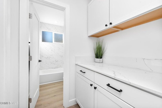 full bath with wood finished floors and vanity