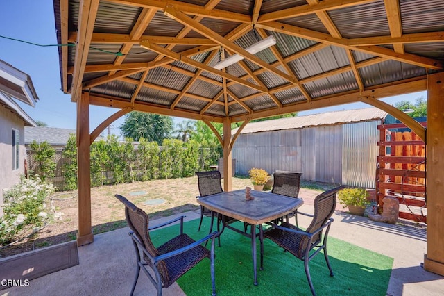 fenced backyard with a patio, a gazebo, and outdoor dining area