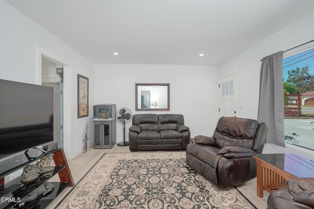 living area with light wood-style flooring and recessed lighting