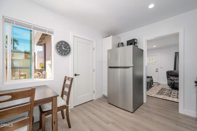 kitchen with freestanding refrigerator, light wood-style floors, recessed lighting, baseboards, and white cabinetry