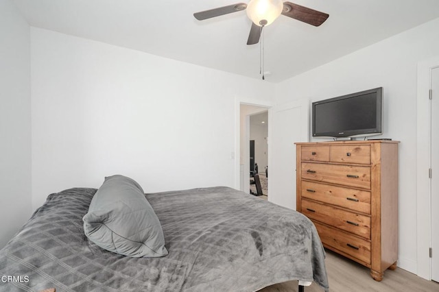 bedroom with light wood finished floors and a ceiling fan