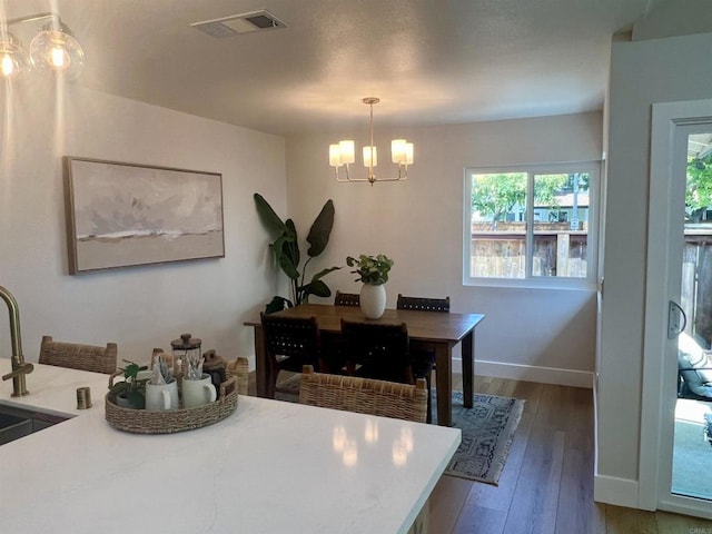 2041 Shadytree Ln, Encinitas, CA 92024 - dining room with a chandelier, hardwood / wood-style flooring, and baseboards
