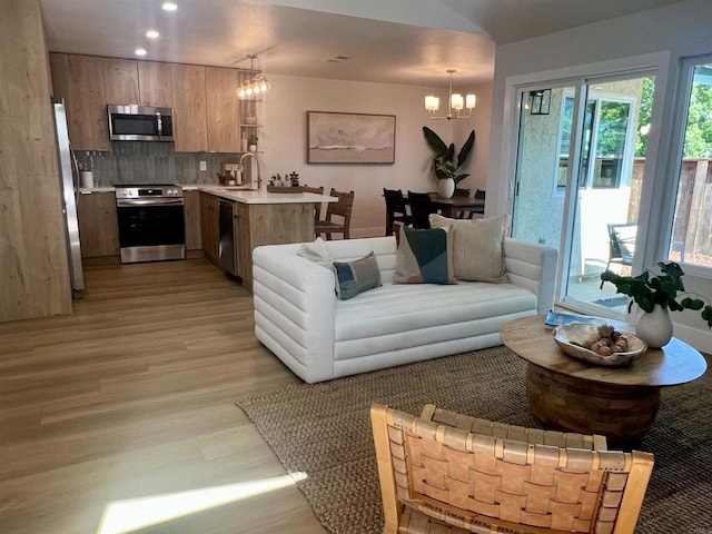 2041 Shadytree Ln, Encinitas, CA 92024 - living room featuring a chandelier, light wood-style flooring, plenty of natural light, and recessed lighting