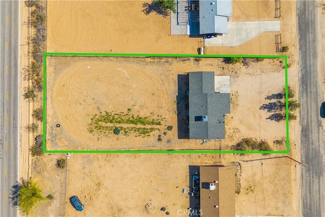 aerial view of property and surrounding area featuring property parcel outlined