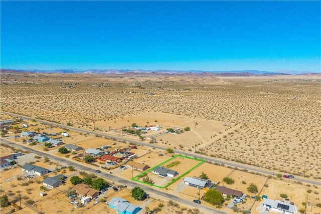 view of rural area with a desert landscape and a mountainous background