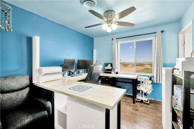 home office featuring wood finished floors and ceiling fan