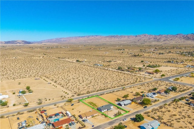 aerial view of sparsely populated area featuring a desert landscape and mountains