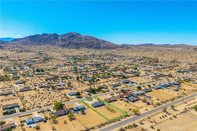 aerial view of a mountain backdrop and a desert landscape