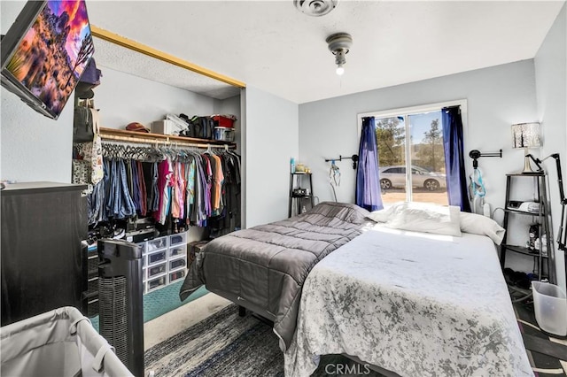 carpeted bedroom with access to outside and a closet