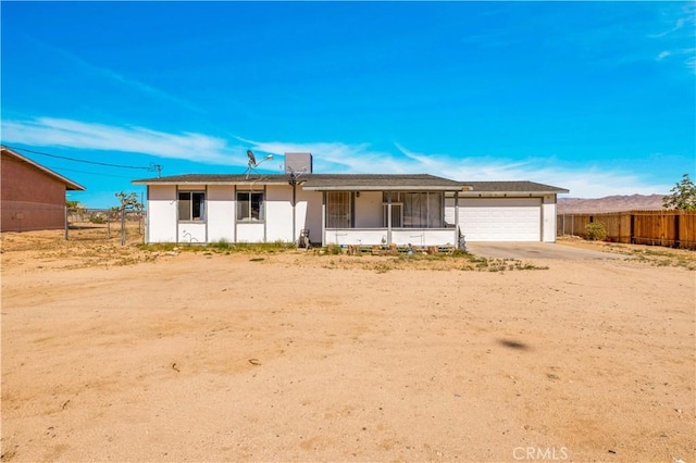 ranch-style home featuring an attached garage and driveway