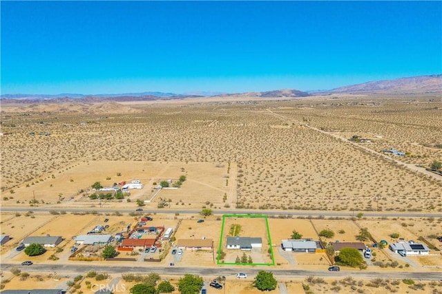 view of rural area featuring mountains, a desert landscape, and property parcel outlined