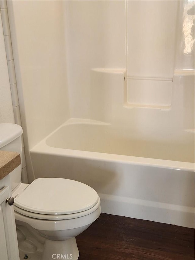 60824 Stagemans Rd, Landers, CA 92285 - full bath with wood finished floors, toilet, vanity, and tub / shower combination
