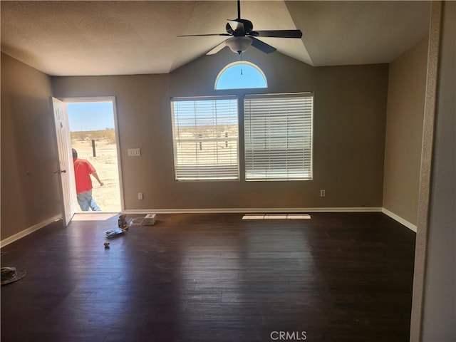 60824 Stagemans Rd, Landers, CA 92285 - spare room featuring a ceiling fan, wood finished floors, vaulted ceiling, and baseboards