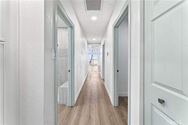 5331 E Ocean Blvd, Long Beach, CA 90803 - corridor with light wood-style flooring, baseboards, recessed lighting, and a textured wall