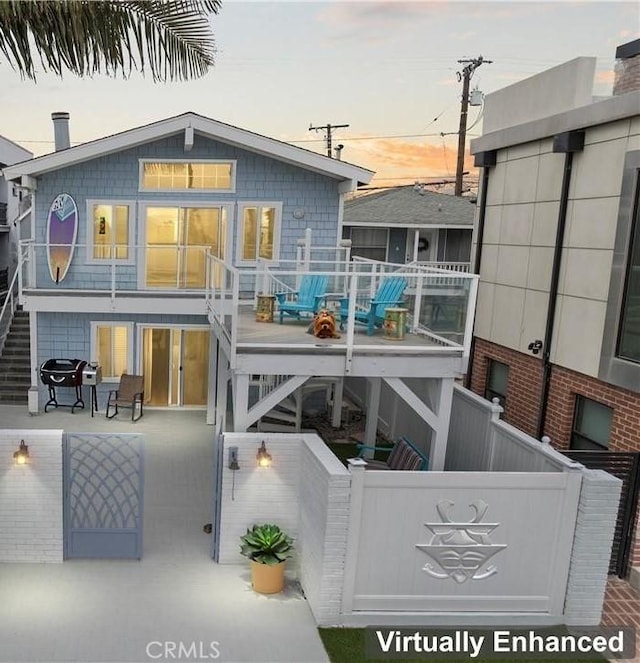 5331 E Ocean Blvd, Long Beach, CA 90803 - back of property at dusk with stairway and a wooden deck