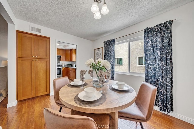 109 N Nicholson Ave Unit A, Monterey Park, CA 91755 - dining area featuring light wood-style flooring, a textured ceiling, and baseboards