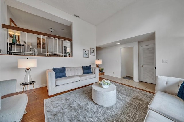 109 N Nicholson Ave Unit A, Monterey Park, CA 91755 - living room with baseboards, a towering ceiling, and wood finished floors