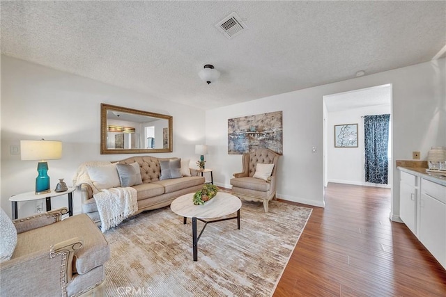 109 N Nicholson Ave Unit A, Monterey Park, CA 91755 - living area featuring wood finished floors, a textured ceiling, and baseboards