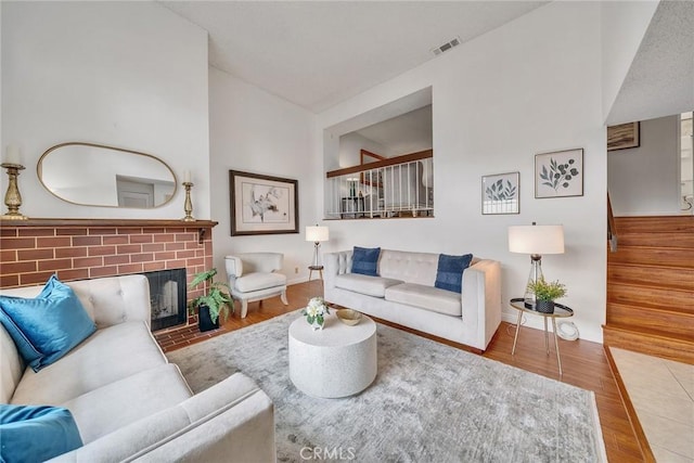 109 N Nicholson Ave Unit A, Monterey Park, CA 91755 - living area with wood finished floors, a brick fireplace, stairway, and baseboards