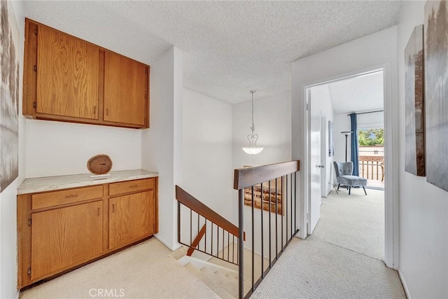 109 N Nicholson Ave Unit A, Monterey Park, CA 91755 - hallway featuring an upstairs landing, light colored carpet, and a textured ceiling