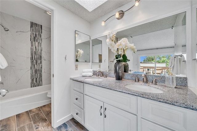109 N Nicholson Ave Unit A, Monterey Park, CA 91755 - bathroom featuring double vanity, a textured ceiling,  shower combination, toilet, and wood finish floors
