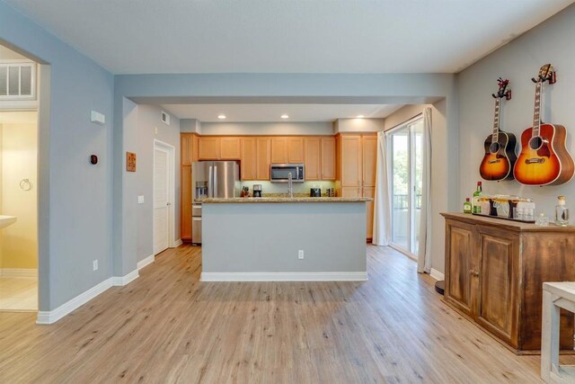 178 Via Montisi, Santee, CA 92071 - kitchen with appliances with stainless steel finishes, light wood-style flooring, baseboards, recessed lighting, and a kitchen island with sink