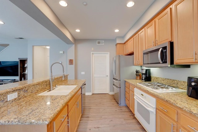 178 Via Montisi, Santee, CA 92071 - kitchen featuring stainless steel appliances, a sink, light brown cabinetry, light wood-type flooring, and light stone counters