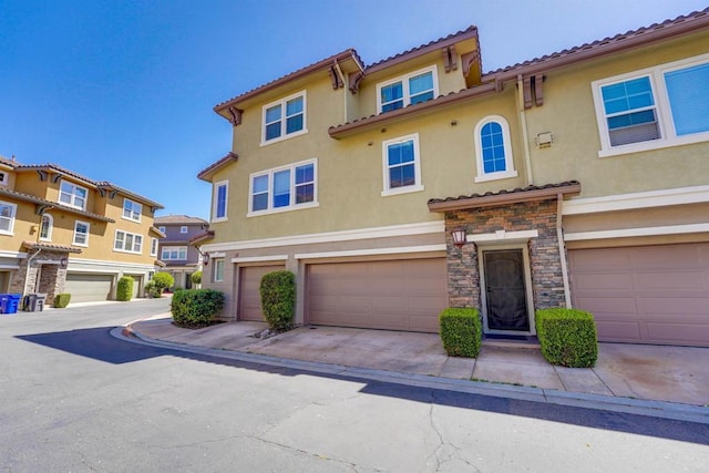 178 Via Montisi, Santee, CA 92071 - view of front facade featuring stucco siding, stone siding, a tile roof, a garage, and concrete driveway