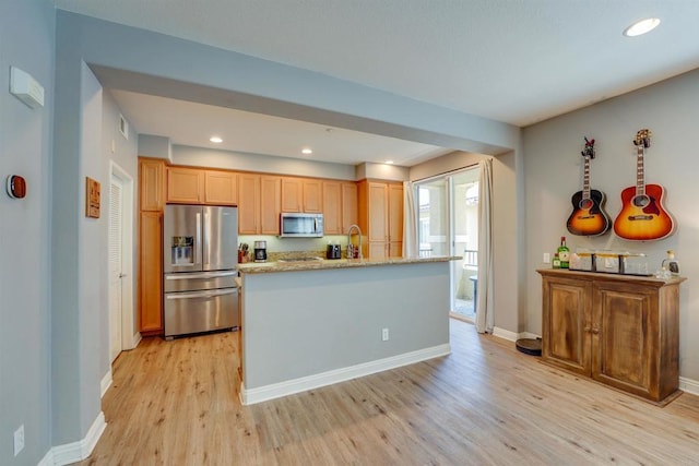 178 Via Montisi, Santee, CA 92071 - kitchen with appliances with stainless steel finishes, light wood finished floors, baseboards, a kitchen island with sink, and a sink