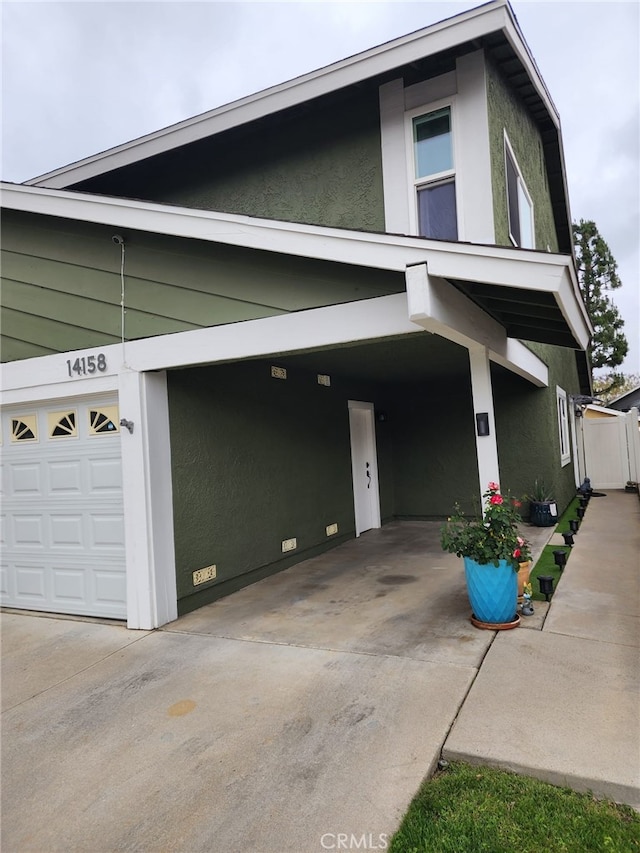 14158 Paddock St, Sylmar, CA 91342 - view of front of home featuring a garage, concrete driveway, stucco siding, and crawl space