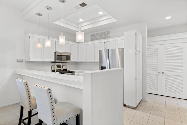 16054 Circa De Lindo, Rancho Santa Fe, CA 92091 - kitchen featuring appliances with stainless steel finishes, a kitchen breakfast bar, light tile patterned floors, light countertops, and a peninsula