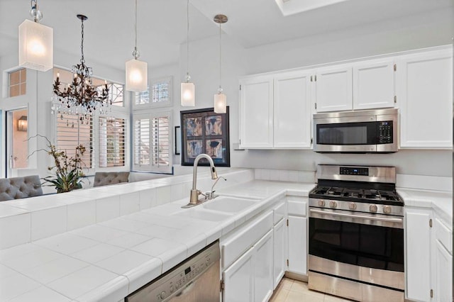 16054 Circa De Lindo, Rancho Santa Fe, CA 92091 - kitchen featuring stainless steel appliances, a sink, tile countertops, white cabinetry, and a peninsula