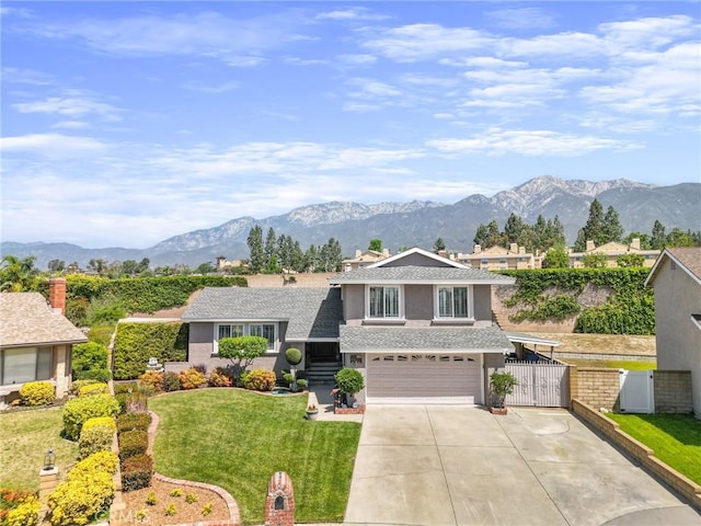 split level home featuring driveway, a mountain view, and an attached garage