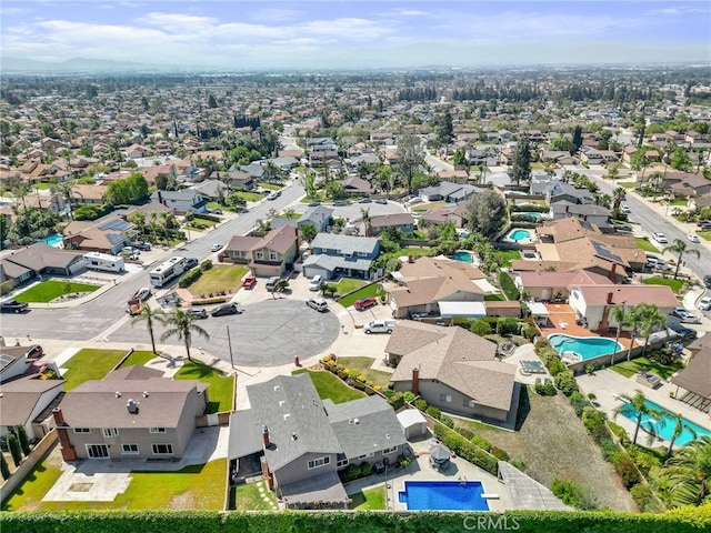 aerial perspective of suburban area featuring a pool